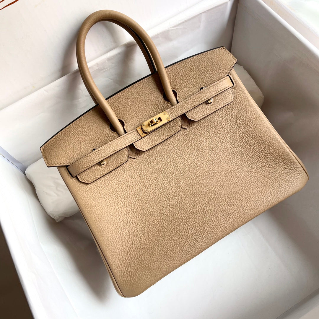 13342606522628715_2fcd7438-6f57-42ba-860c-37bd209deece.jpg HN 25CM BEIGE TOGO LEATHER GOLD HARDWARE - Image 1