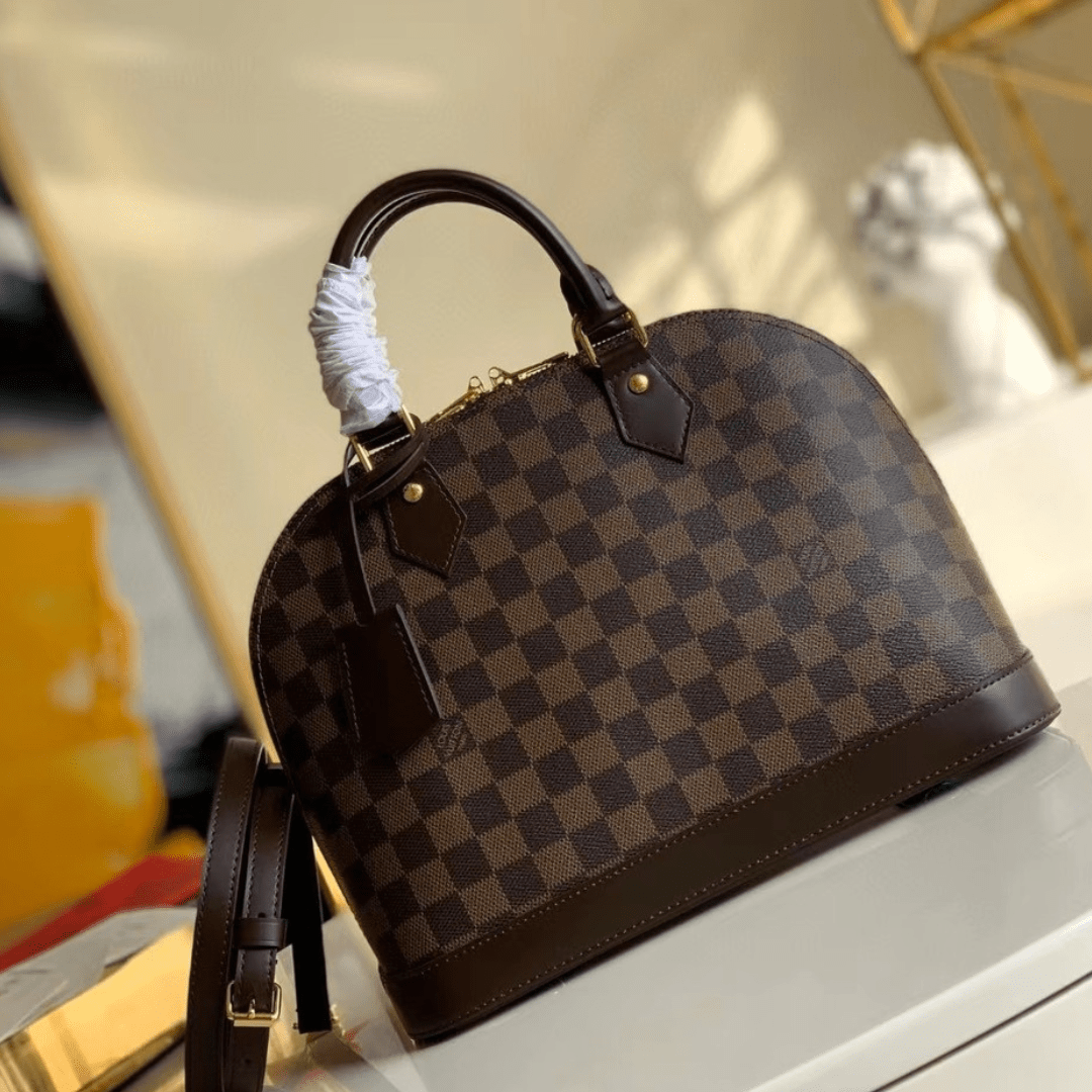 Untitled-design-2025-05-27T042005.049.png Louis Vuitton Damier Ebene Alma PM Caro Pattern Handbags 32mm - Image 1