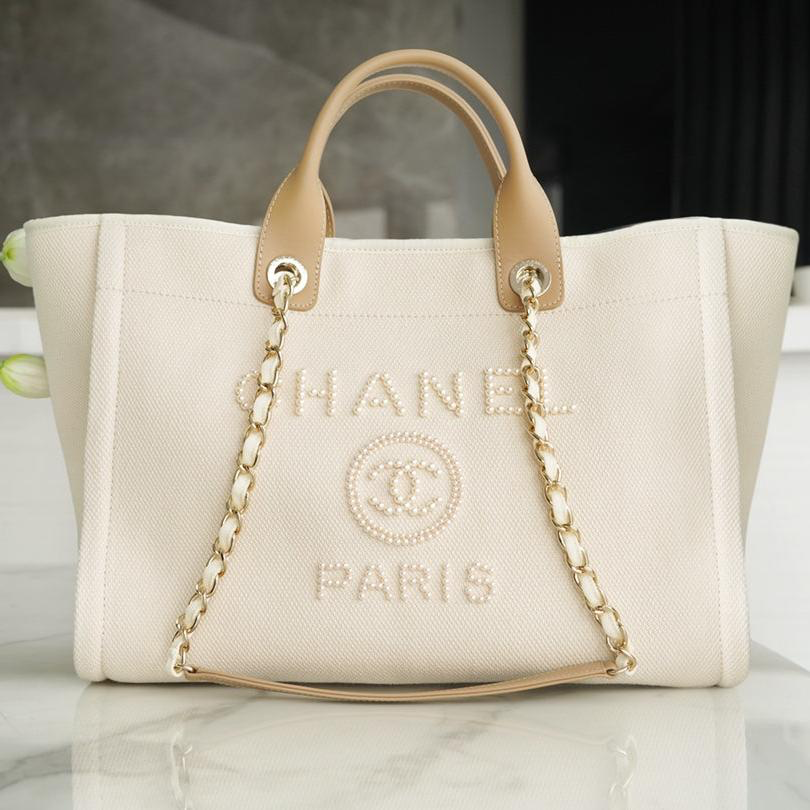 img_0141-1.png CHANEL TOTE BAG 39 ATTACHED PEARL LOGO IN BEIGE CANVAS GOLD HARDWARE - Image 1